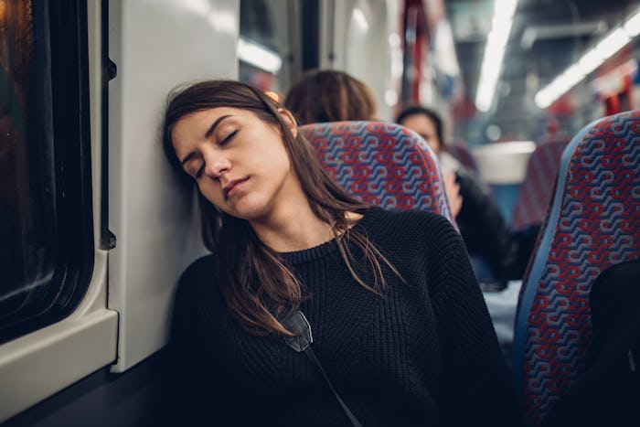 exhausted woman sleeping on train