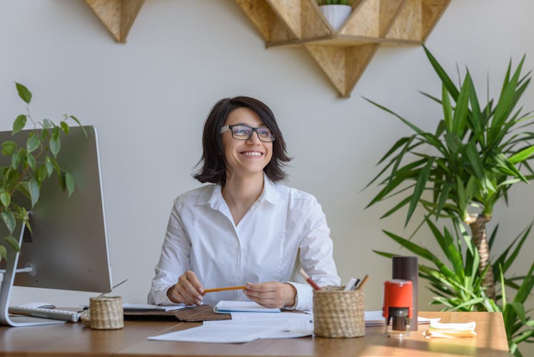 Woman smiling at office during working day