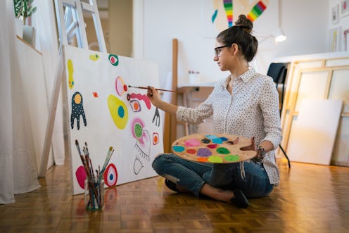 Getting creative.woman painting in her art studio