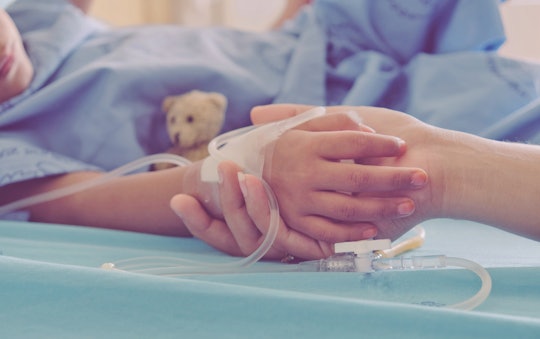 Mother holding child's hand who fever patients in hospital to give encouragement.