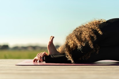 woman doing yoga exercise away from city life	