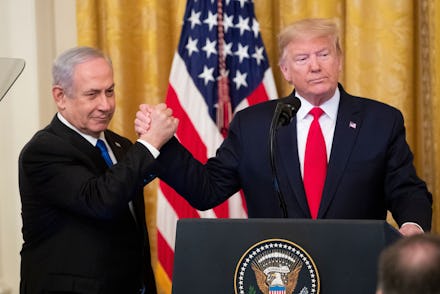 US President Donald J. Trump (R) shakes hands with Prime Minister of Israel Benjamin Netanyahu while...