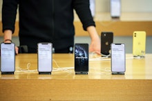 A customer looks on an iPhones 11 Pro Max at the Apple Store during the start of sales of the iPhone...