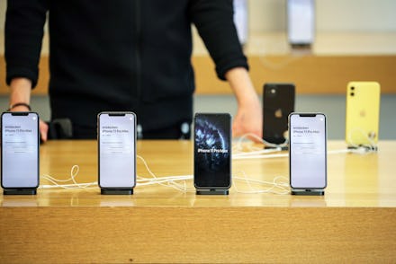 A customer looks on an iPhones 11 Pro Max at the Apple Store during the start of sales of the iPhone...