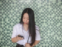 Young women use mobile phones