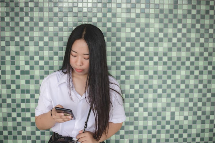 Young women use mobile phones