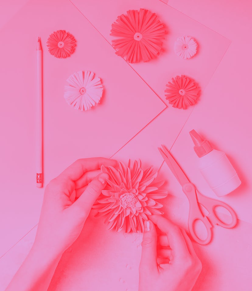  Female hands makes paper flower art. DIY concept. Pastel colors, flat lay.