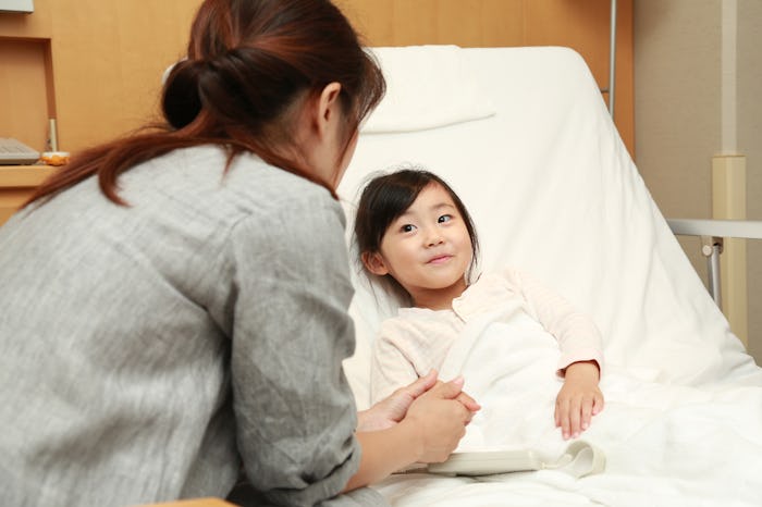 a little girl in a hospital bed