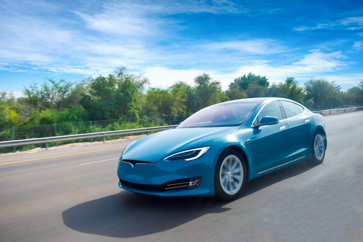 An electric car cruising on the highway,bluish sky and beautiful climate.green energy concept.