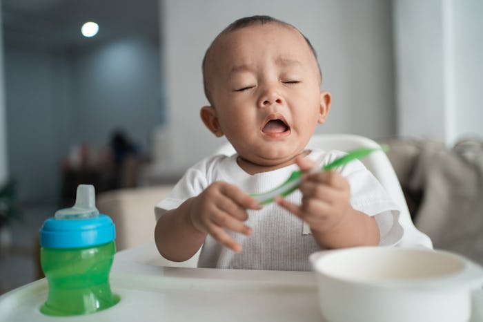 baby boy coughing/sneezing while sitting on high chair