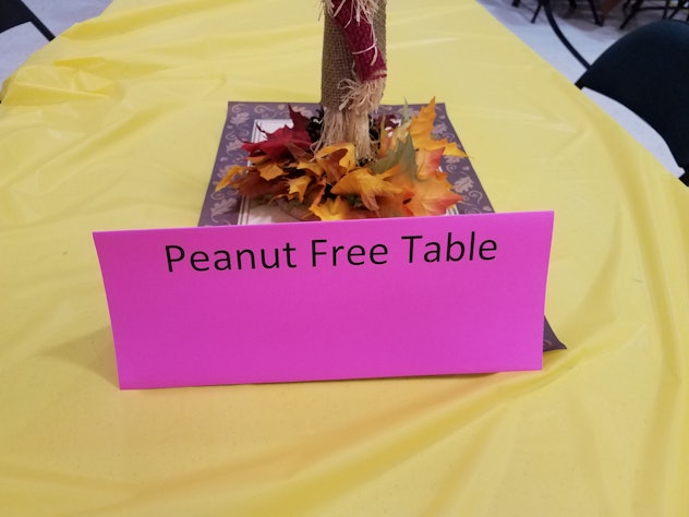 pink peanut free sign on table with leaf decoration