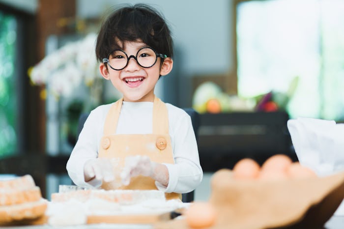 a little boy making breakfast