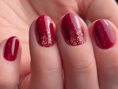 Red gold design nail art in beauty salon