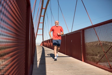Senior runner training on a pedestrian bridge