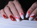 red manicure design with the image of spilled paint on a light background