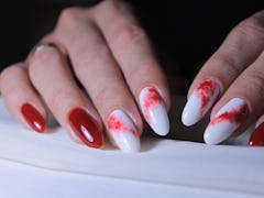red manicure design with the image of spilled paint on a light background