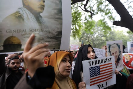 Shia Muslim community people hold portraits during the protest.
Shia Muslim community people protest...