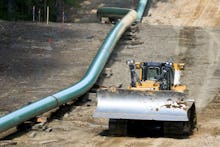 Segments of assembled pipe are lined up along a cleared section of woods where a pipeline for shale ...