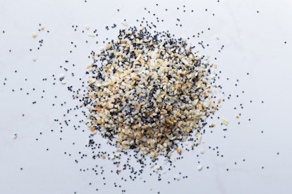 A scattered pile of Everything seasoning containing dried garlic, onion, poppy seeds, sesame seeds a...