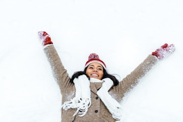attractive african american woman doing snow angel