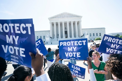 Immigration activists gather outside the US Supreme Court to await the justices' ruling on the Trump...