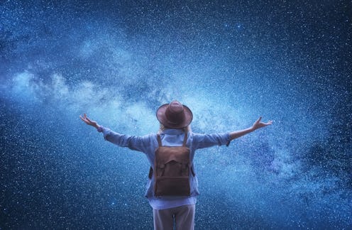 Milky Way. Tourist at the Universe background. Travelers with backpack at the night sky background. ...