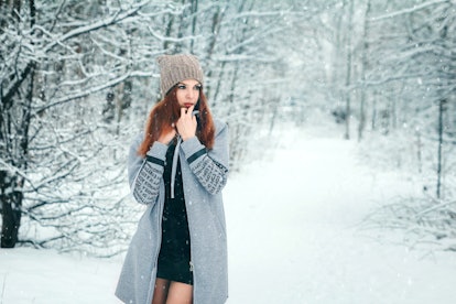 Winter, a girl in a winter forest, snow. Concept of the New Year holidays, rest.