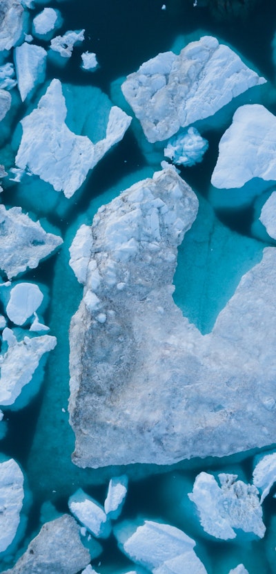 Icebergs drone aerial image top view - Climate Change and Global Warming. Icebergs from melting glac...