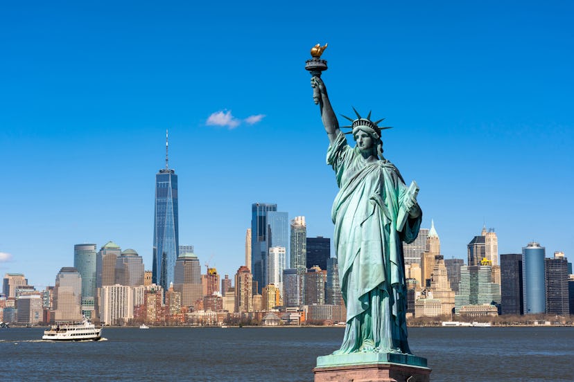 The Statue of Liberty over the Scene of New york cityscape river side which location is lower manhat...