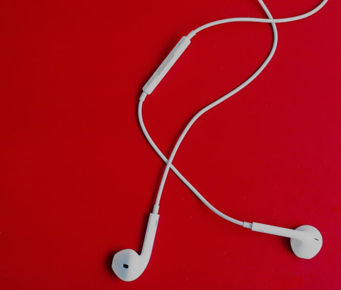White earpods on a red background