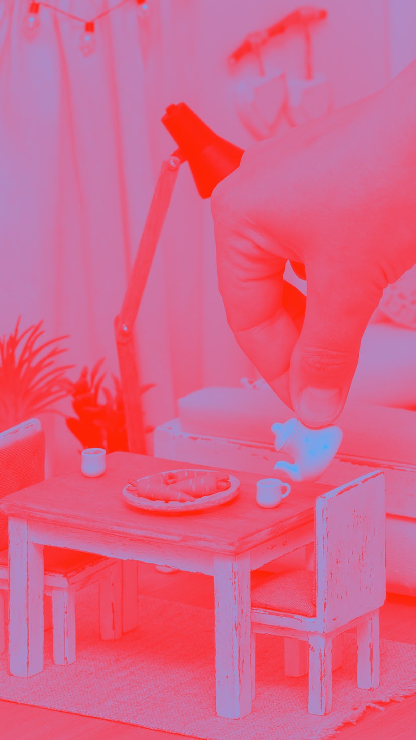 A cheerful bright room in a doll house furnished with miniature furniture, A person serving tea from...