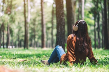 A beautiful asian woman enjoy listening to music with headphone with feeling happy and relaxed in th...