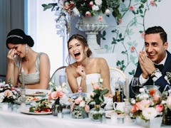 Emotional beautiful newlywed couple smiling at wedding reception