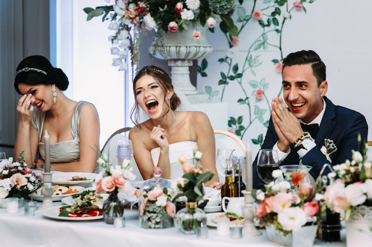 Emotional beautiful newlywed couple smiling at wedding reception