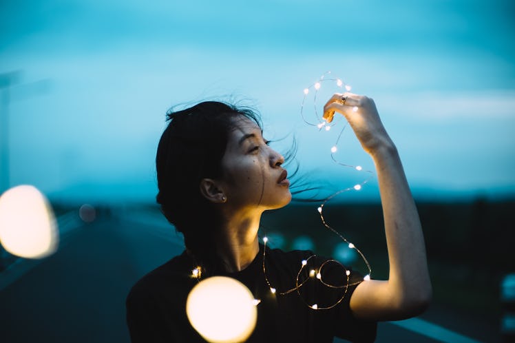 Young woman with fairy light