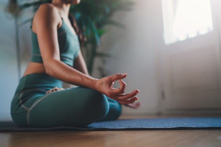 Morning Mindfulness Meditation, Closeup of young woman practicing yoga in the morning sitting straig...
