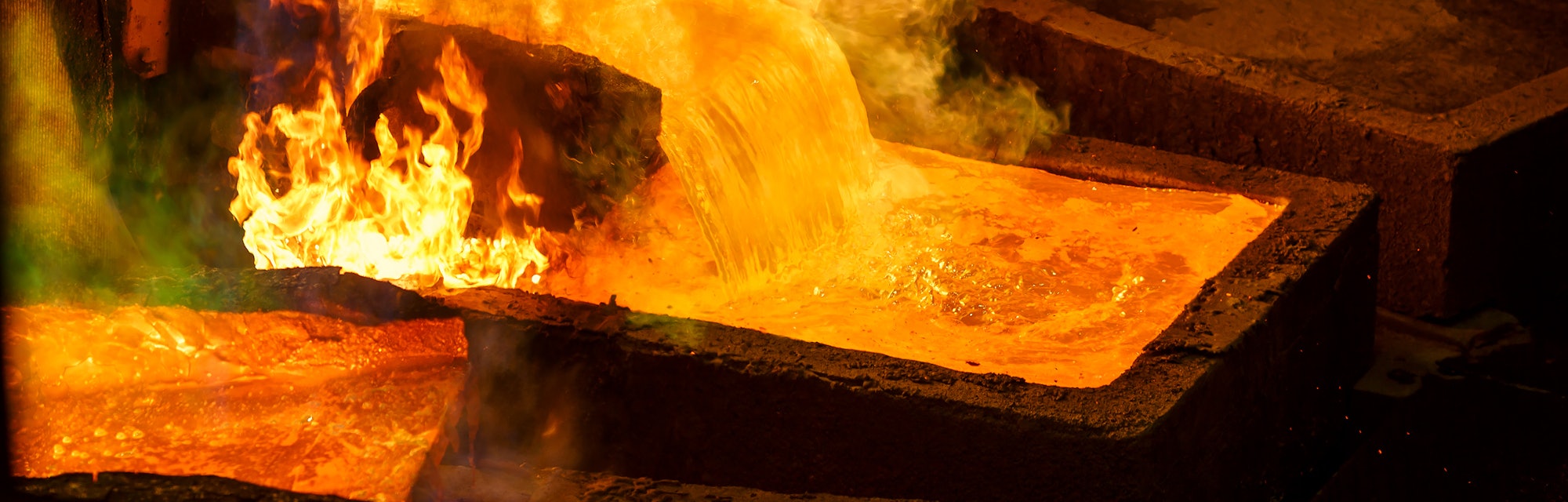 Molten metal is poured into large rectangular molds for casting. When melting the evaporation of gas...