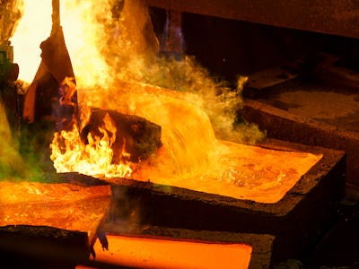 Molten metal is poured into large rectangular molds for casting. When melting the evaporation of gas...