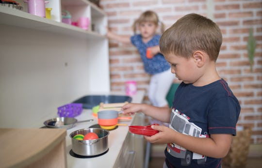 Caucasian little boy is playing at kitchen