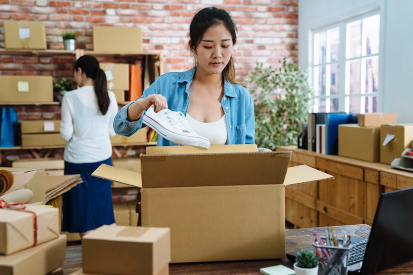 Startup small business entrepreneur SME freelance woman work with box. Young Asian lady worker in of...