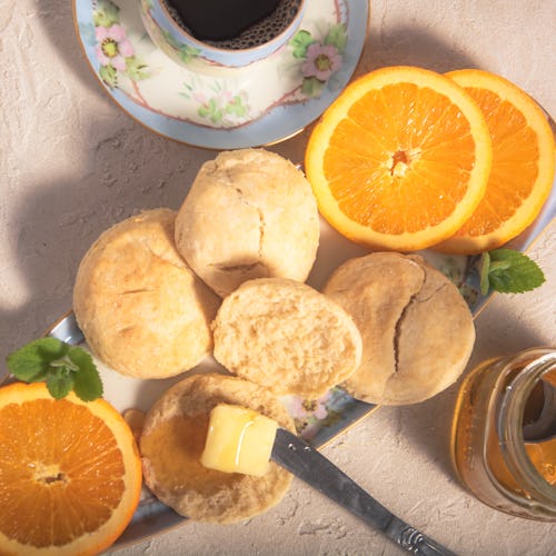 Fresh-baked biscuits with real butter and tupelo honey.  Accompanied by navel orange slices and a ho...