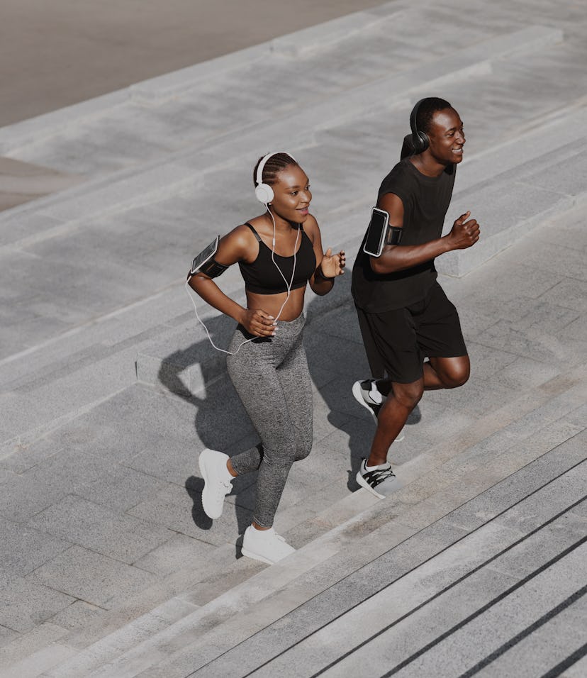 Black Man And Woman Jogging Together In Urban Park, Running Up Steps, Working Out Outdoors, Empty Sp...