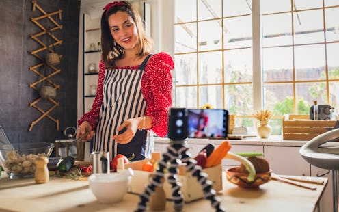 Woman blogging in her kitchen.