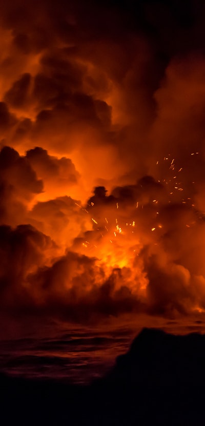 Active lava flow and explosion from the volcano on the Big Island of Hawaii during sunrise