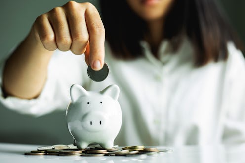 Hand putting coin on pig saving. business, investment, retirement, finance and Money Saving for the ...