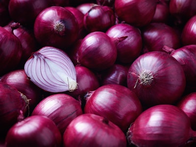 Full Frame Shot Of Purple Onions. Fresh whole purple onions and one sliced onion.