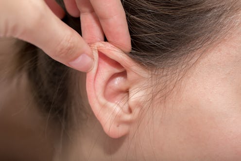 Ears protruding from under the hair, otolaryngologist treatment of diseases in the ears, hearing los...