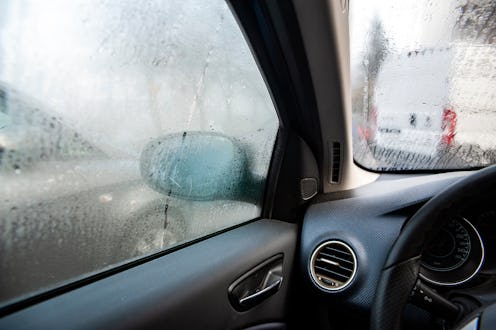 Steamy car window on a autumn rainy/foggy day. Concept of safety driving problem