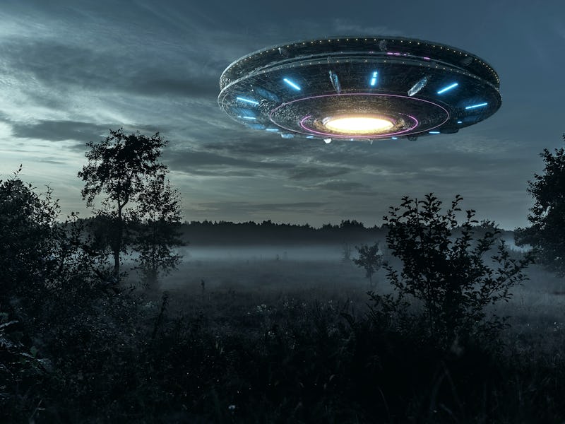 UFO, an alien plate hovering over the field, hovering motionless in the air. Unidentified flying obj...