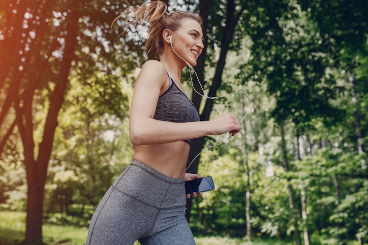 athletic girl running in the Park and doing exercises Jogging